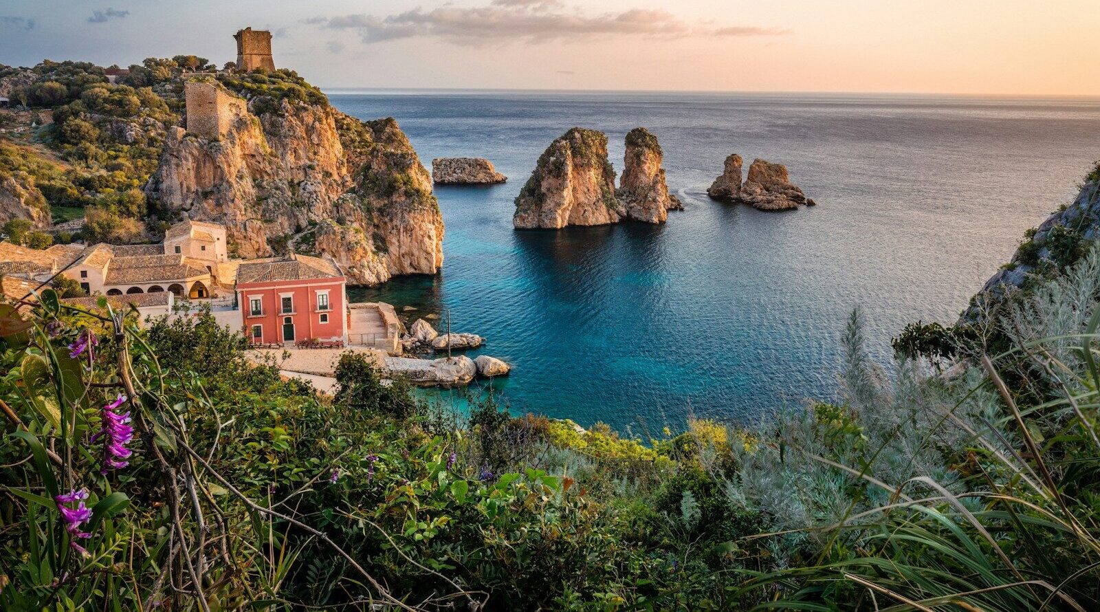 photo of house near cliff and body of water